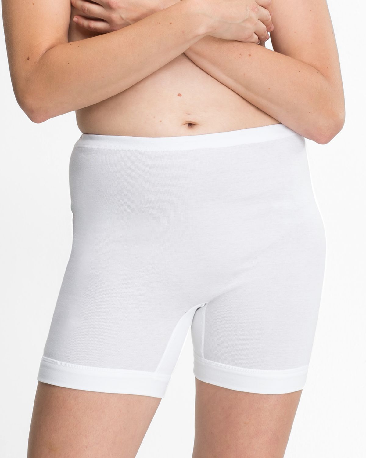 Model trägt Langbeinschlüpfer in weiß aus der Serie Nelly, Ansicht von vorne.