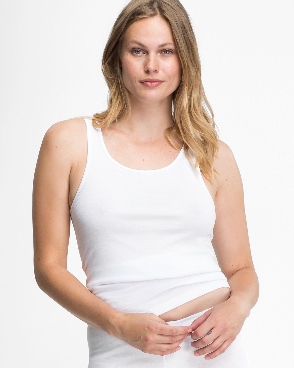 Model trägt Achselhemd in weiß aus der Serie Bio Cotton, Ansicht von vorne.