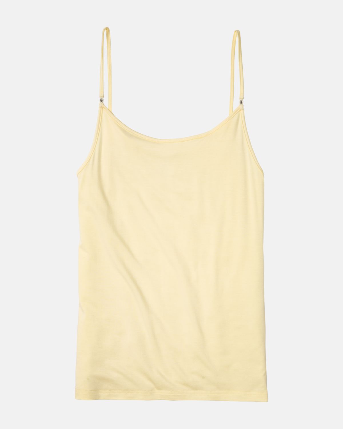 Hemd in zitrone aus der Serie Sensuelle, flach auf einer Oberfläche liegend.