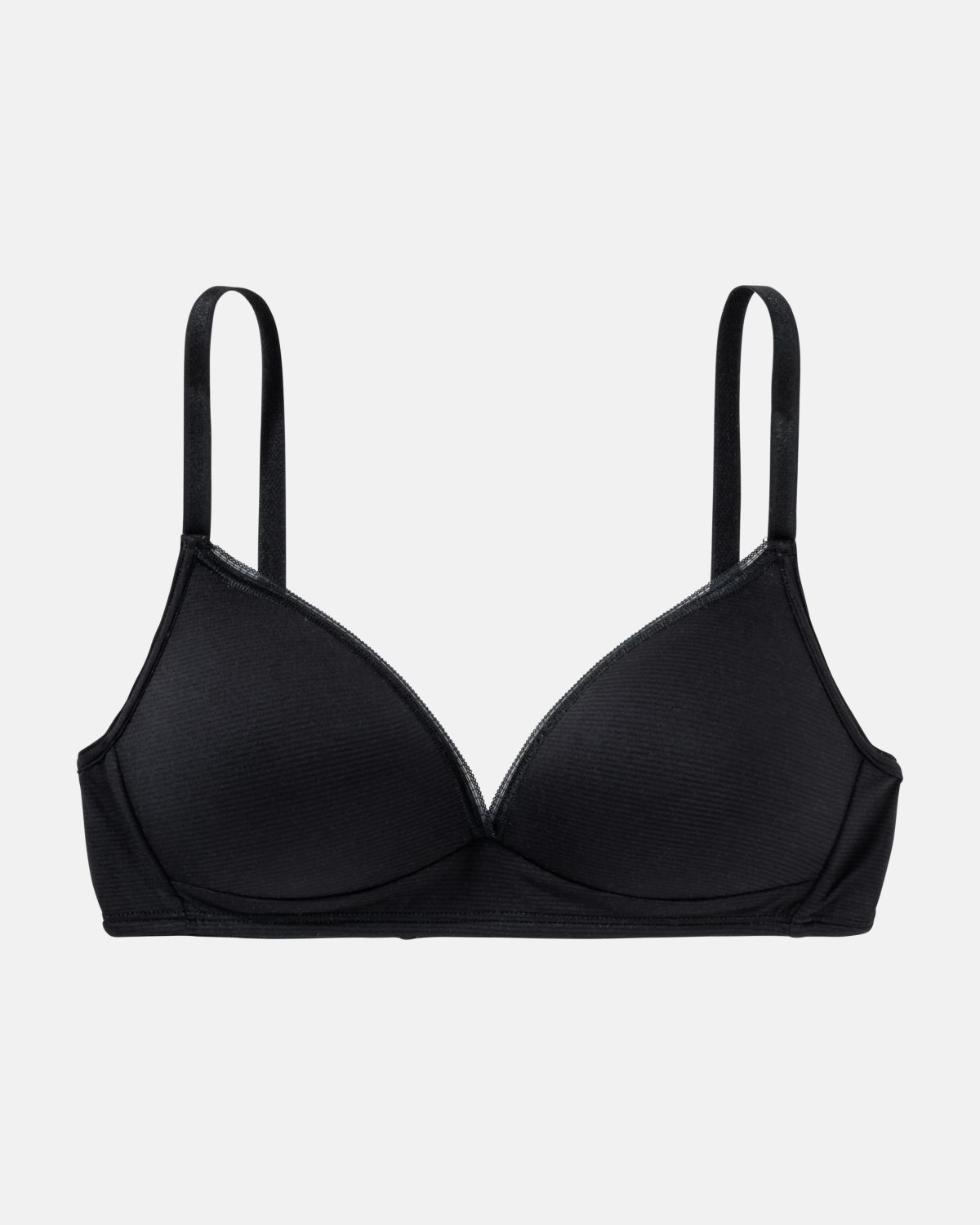 Schalen BH Triangle in schwarz aus der Serie Magic look, flach auf einer Oberfläche liegend.