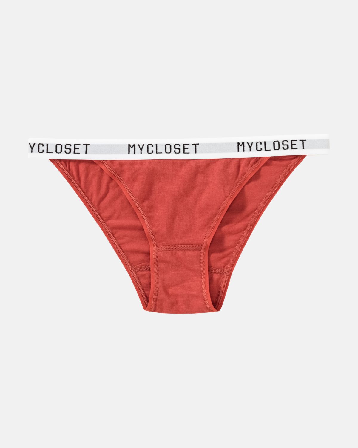 Tanga in pepper aus der Serie Logo Lover, flach auf einer Oberfläche liegend.