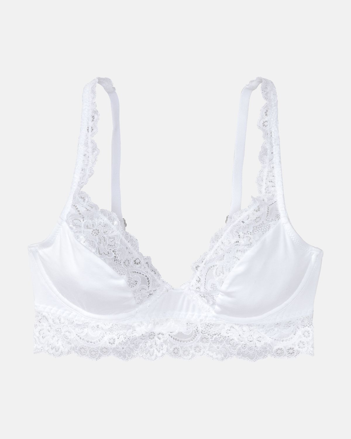 Bügel BH Longline in weiß aus der Serie Sensuelle Lace, flach auf einer Oberfläche liegend.