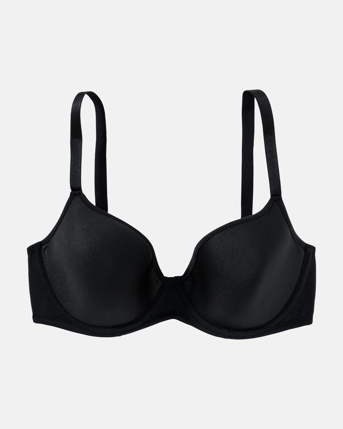 Schalen BH Spacer Cup in schwarz aus der Serie Magic hip, flach auf einer Oberfläche liegend.