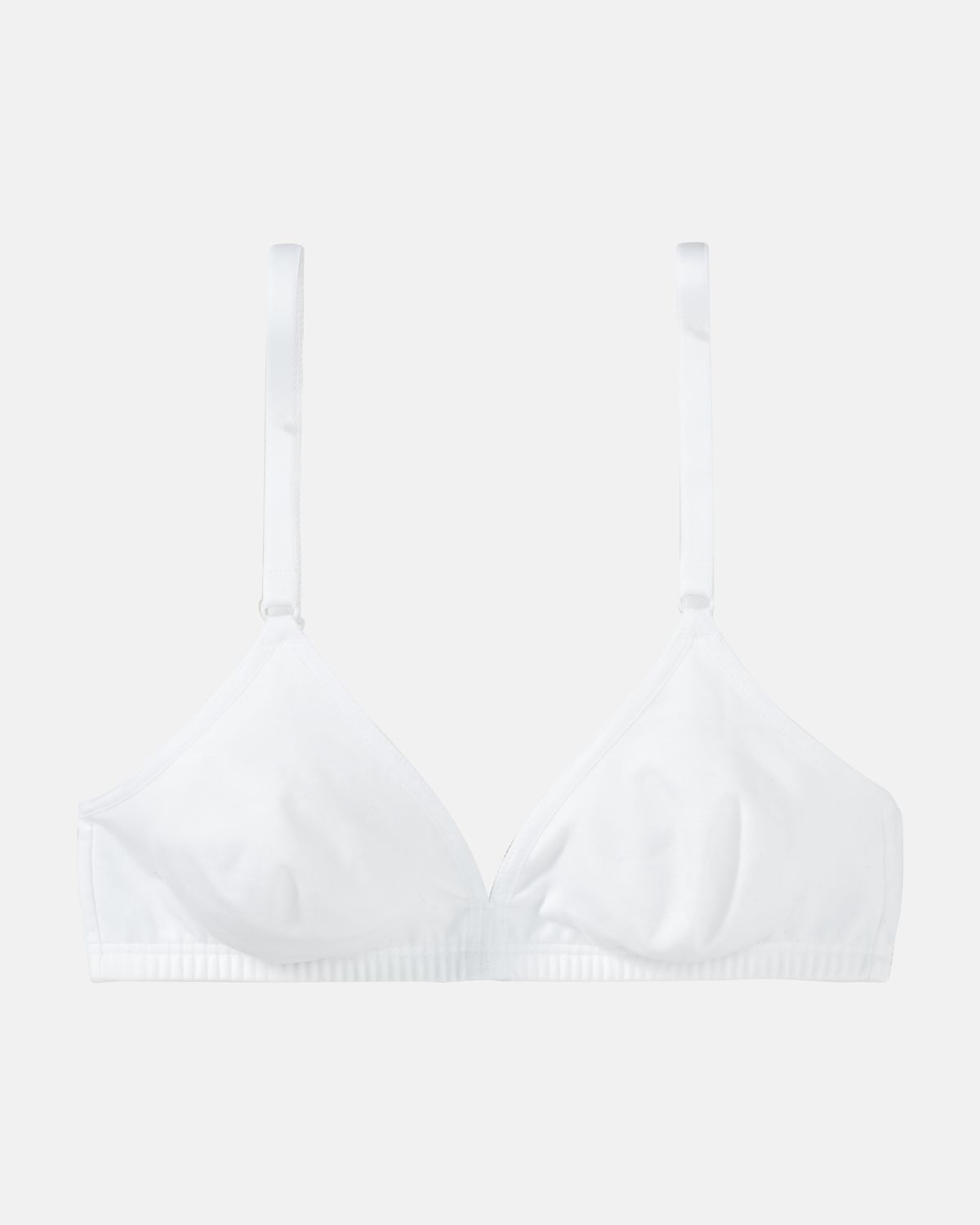 Soft BH gemoldet in weiß aus der Serie Softfeeling, flach auf einer Oberfläche liegend.