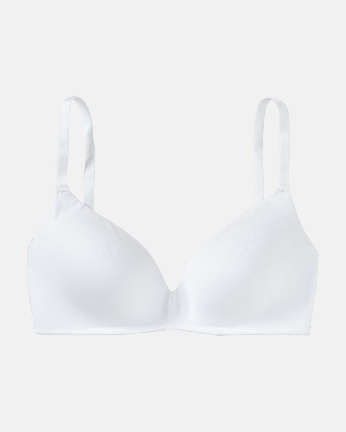 Schalen BH non wired in weiß aus der Serie Softfeeling, flach auf einer Oberfläche liegend.