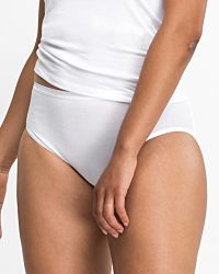 Model trägt Hüftslip in weiß aus der Serie Nadine, Ansicht von vorne.