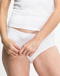 Model trägt Maxislip in weiß aus der Serie Silke, Ansicht von vorne.