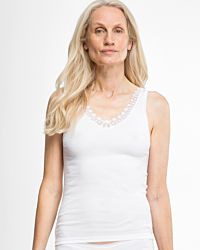 Model trägt Achselhemd in weiß aus der Serie Silke, Ansicht von vorne.