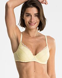 Model trägt Schalen BH mit Bügel in zitrone aus der Serie Romy, Ansicht von vorne.