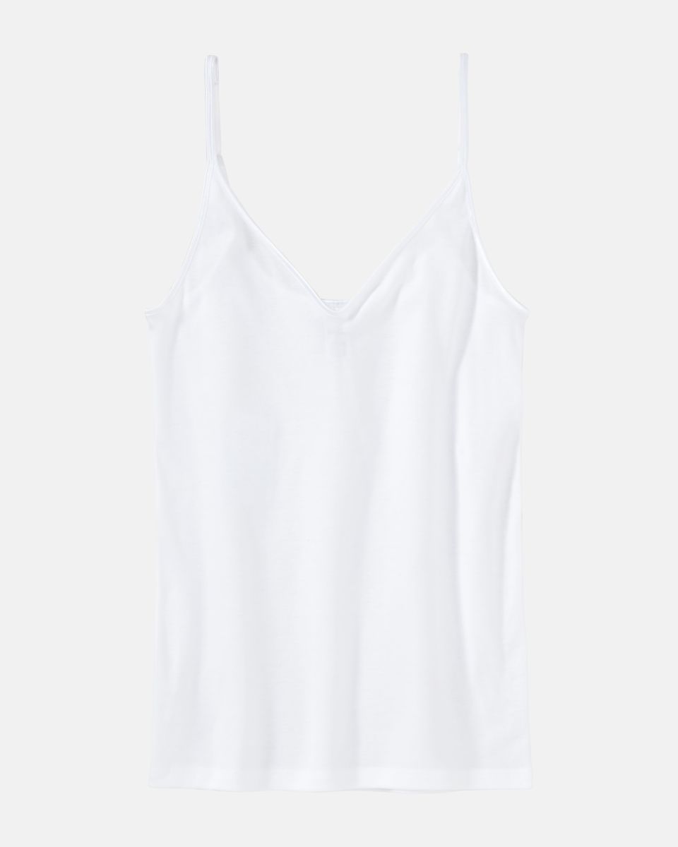 Trägerhemd in weiß aus der Serie Natascha, flach auf einer Oberfläche liegend.