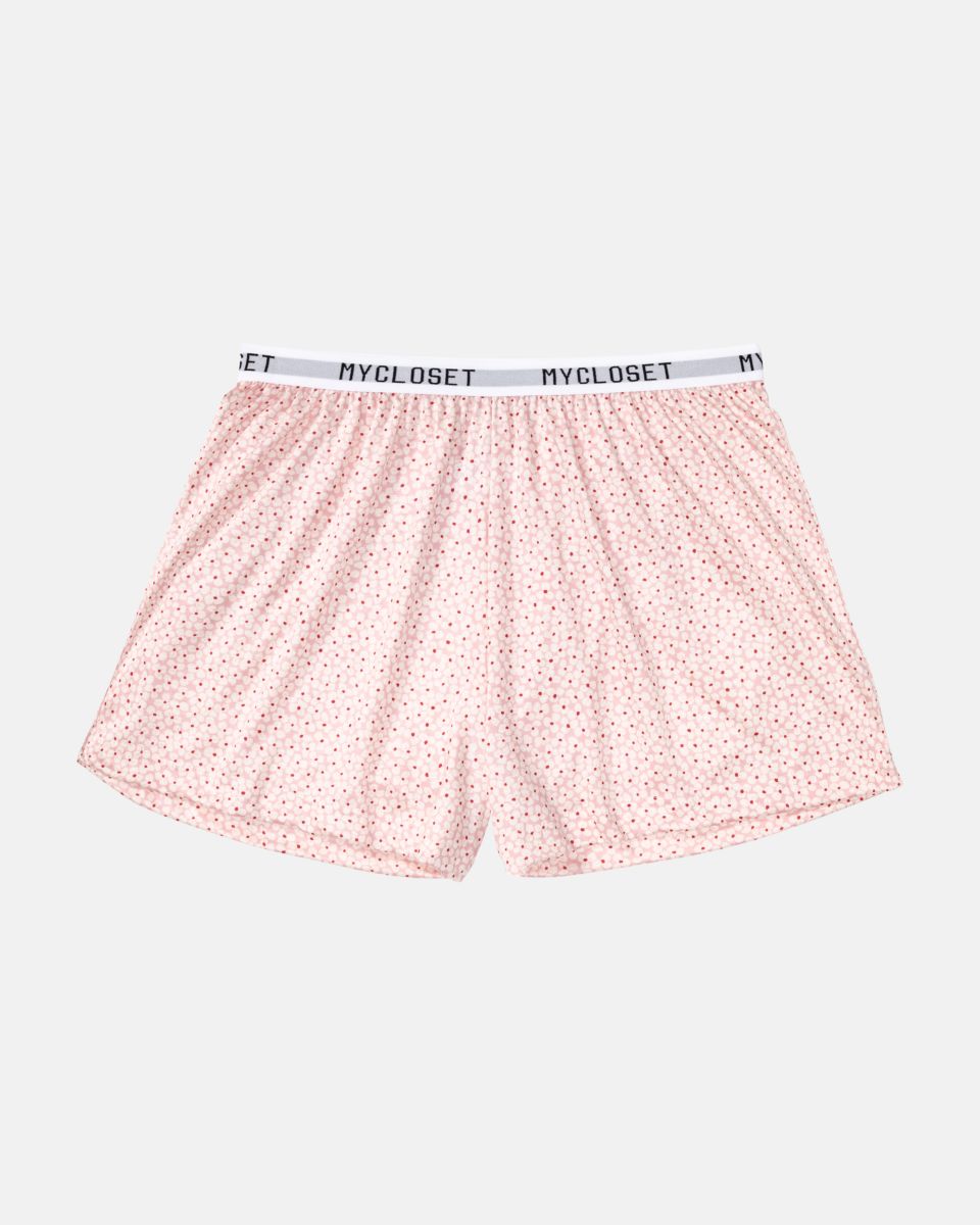 Shorts in floral aus der Serie Logo Lover, flach auf einer Oberfläche liegend.