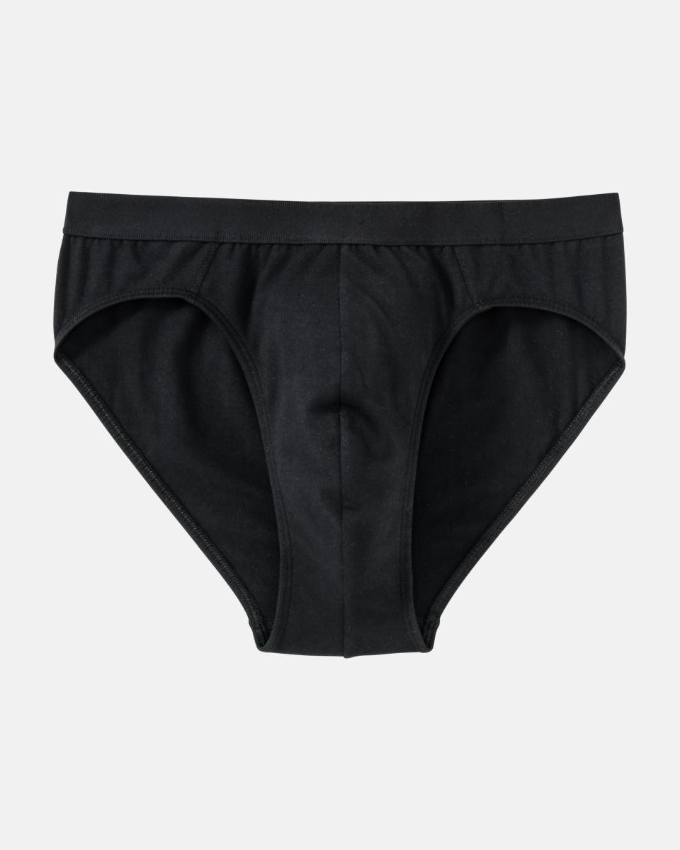 Herren Slip in schwarz aus der Serie Classic, flach auf einer Oberfläche liegend.
