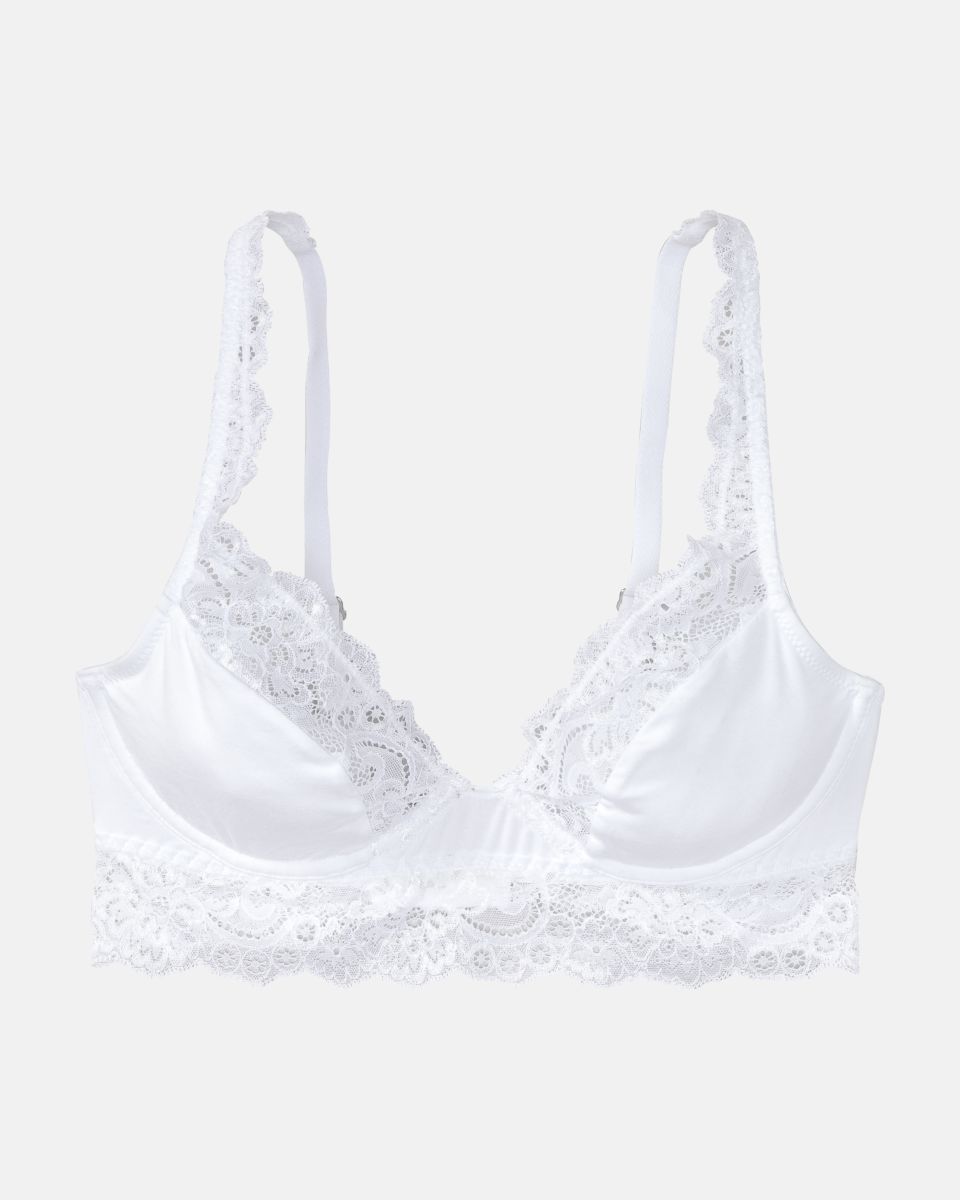 Bügel BH Longline in weiß aus der Serie Sensuelle Lace, flach auf einer Oberfläche liegend.