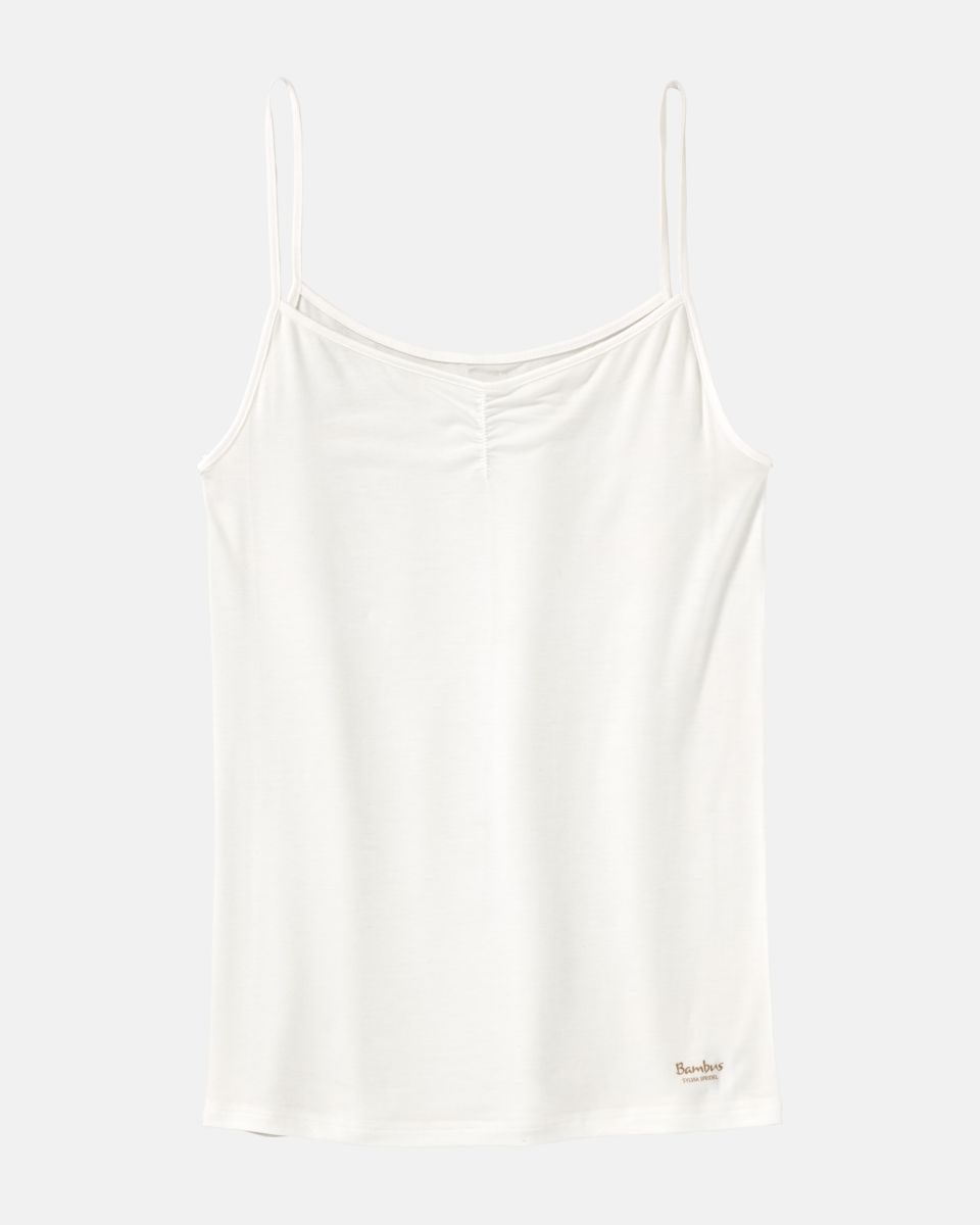 Hemd in elfenbein aus der Serie Swenja, flach auf einer Oberfläche liegend.