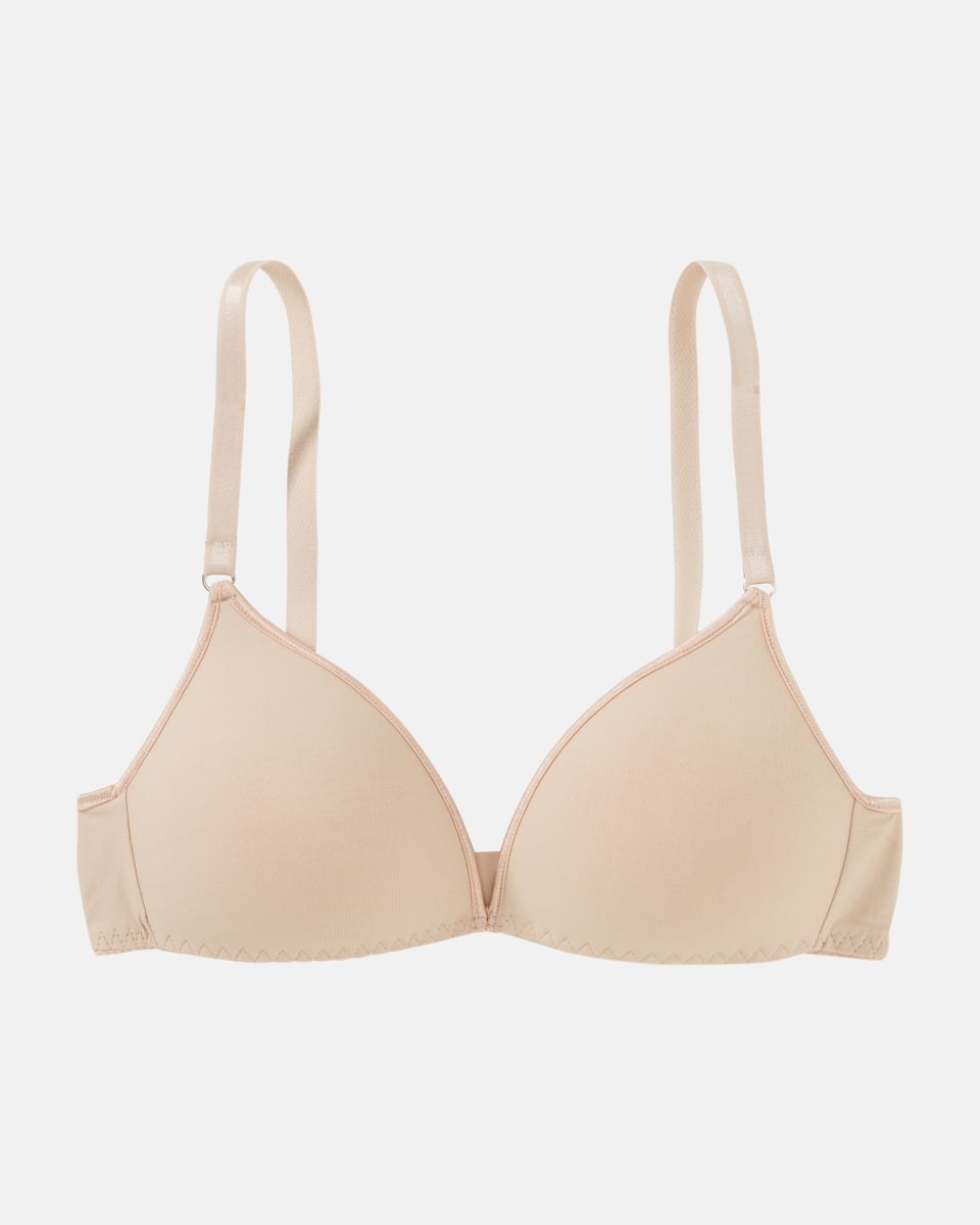 Schalen BH Triangle in skin aus der Serie Magic hip, flach auf einer Oberfläche liegend.