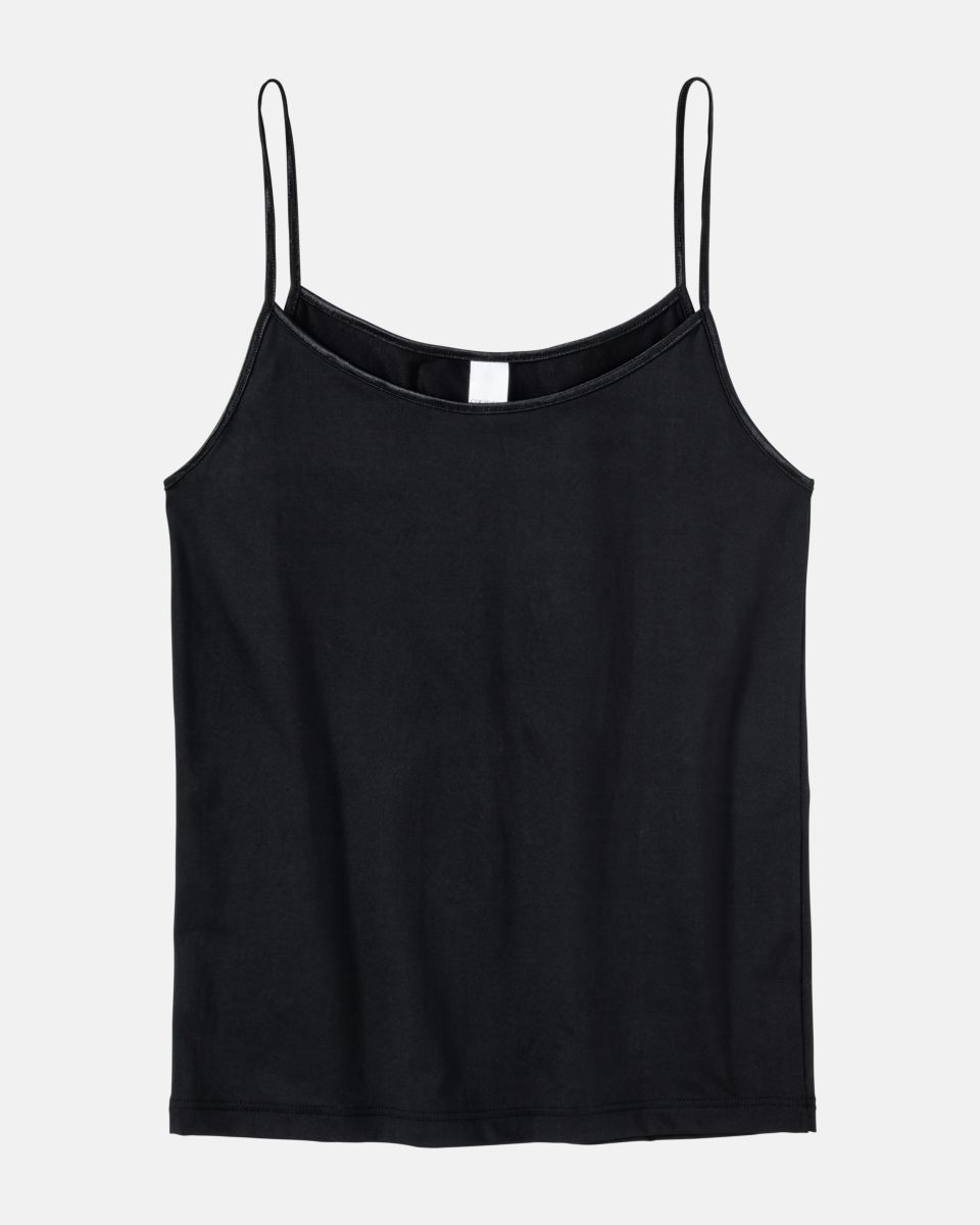 Hemd in schwarz aus der Serie Magic hip, flach auf einer Oberfläche liegend.