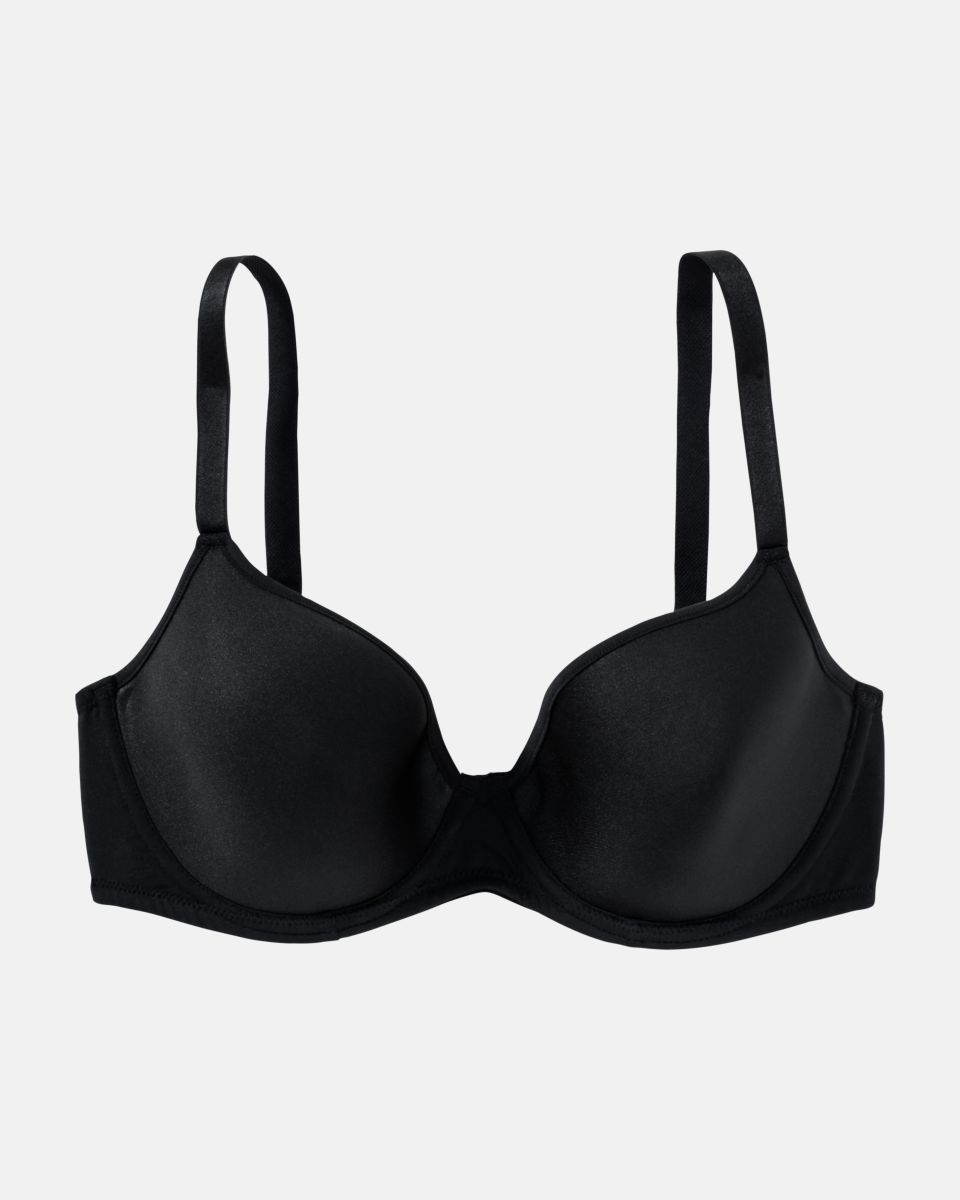 Schalen BH Spacer Cup in schwarz aus der Serie Magic hip, flach auf einer Oberfläche liegend.