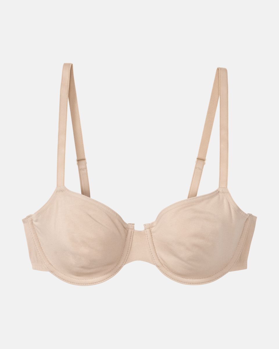Bügel BH in skin aus der Serie Softfeeling, flach auf einer Oberfläche liegend.